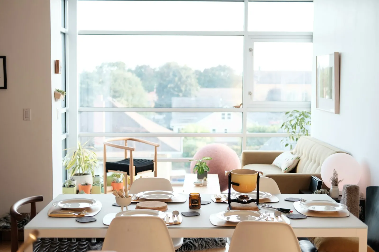 Furnished apartment living and dining area with large windows