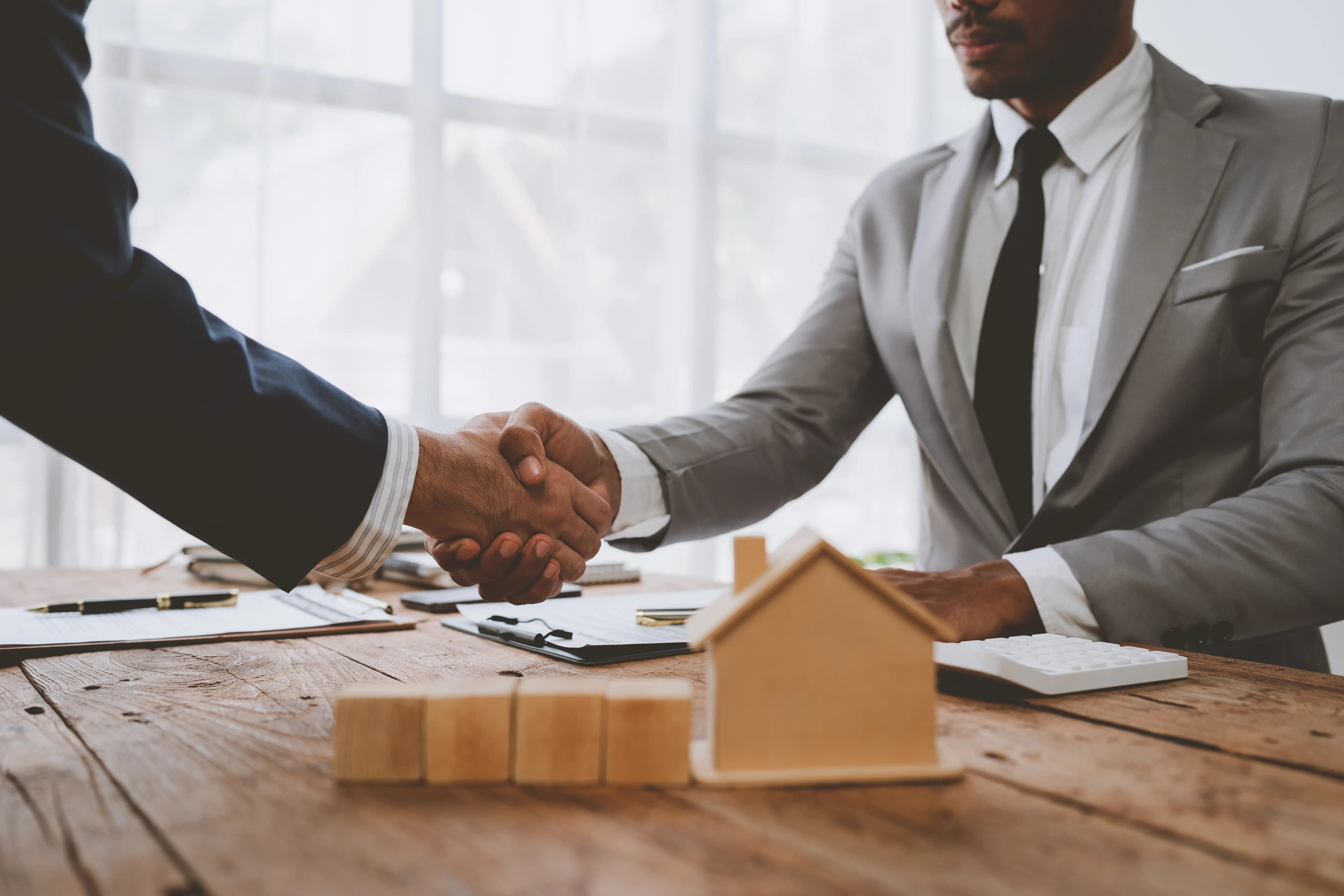 Seven Century real estate advisors shaking hands with a client