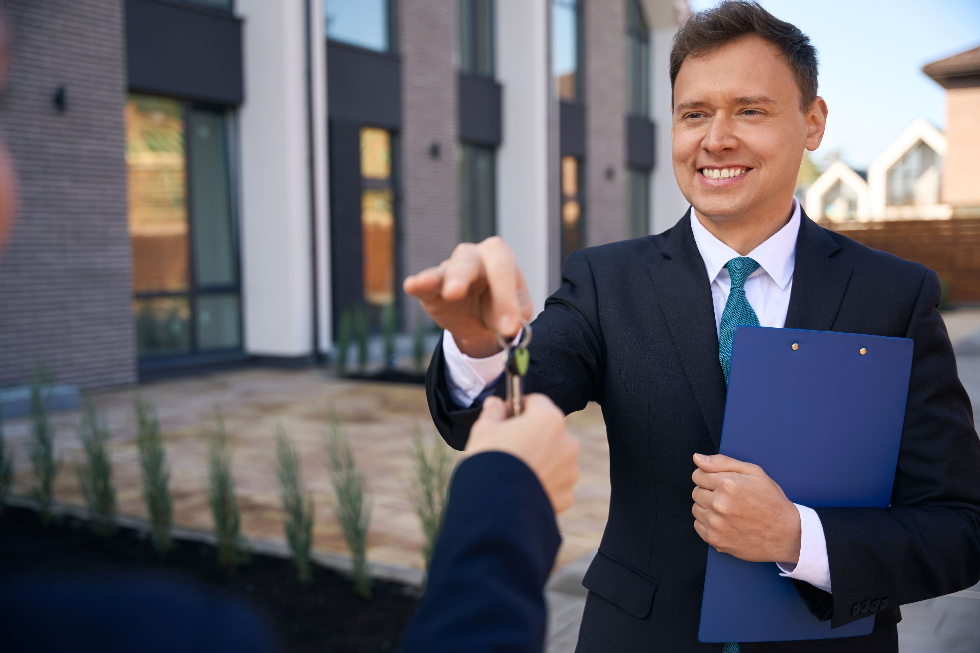 Property manager handing over keys to a client