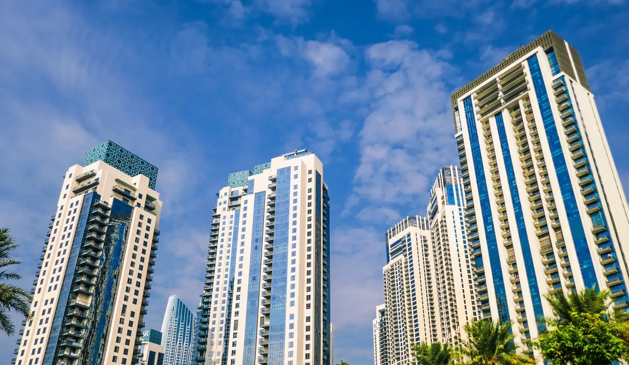 Residential apartment towers in Dubai against a blue sky